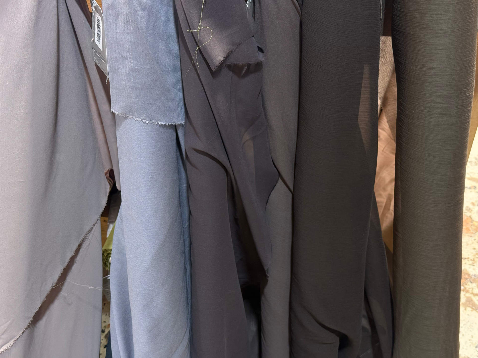 Fabric rolls in grey, blue and dark tones